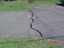 thumbnail of house with driveway/ground crack