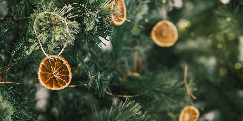 Rustic decorated ornament on Christmas tree with dried orange slices