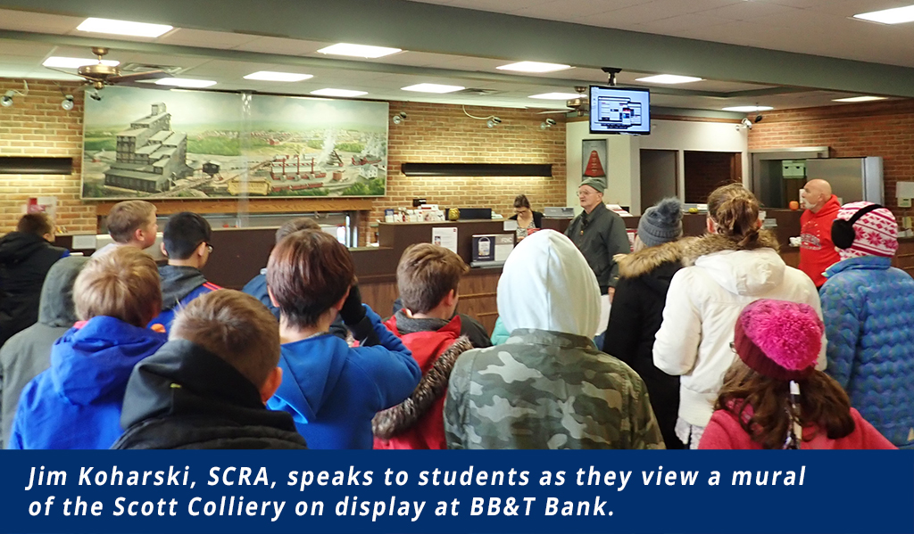 Students view a mural of the Scott Colliery