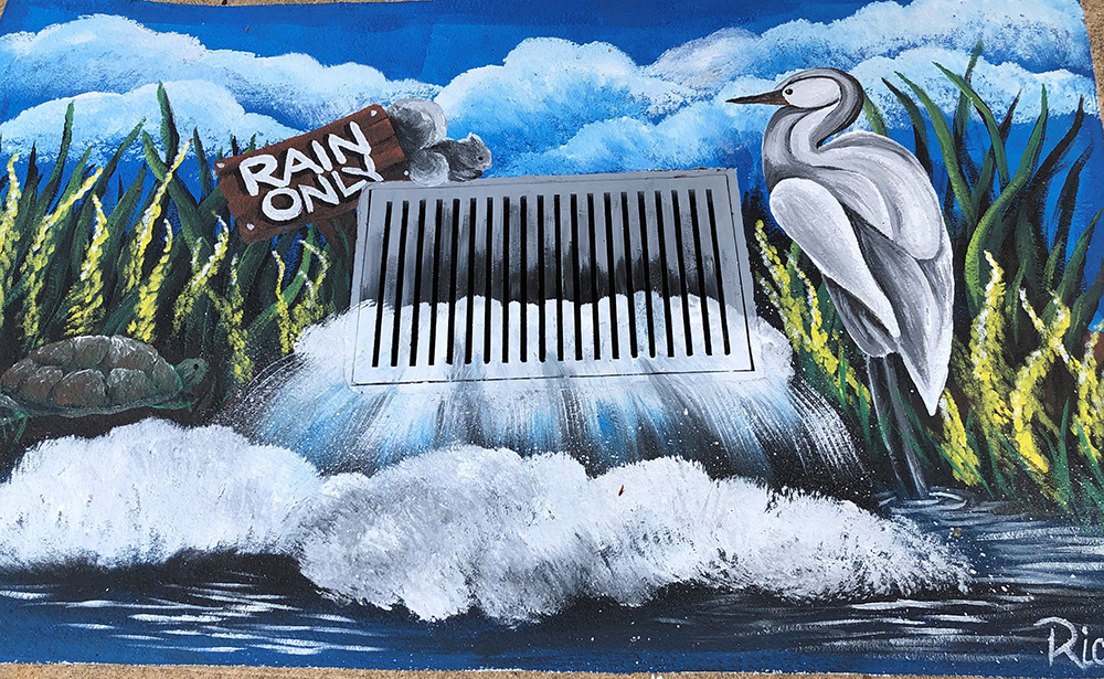 A storm drain painted to show water gushing into a stream surrounded by a grey heron, squirell, turtle, plants and reeds