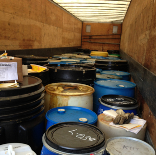 Barrels of contaminants in a disposal truck