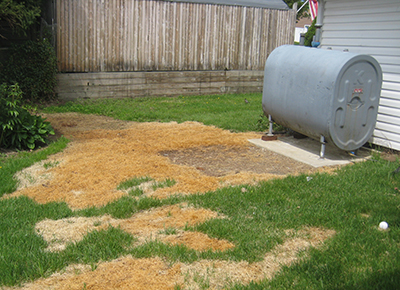 An outdoor home heating oil tank spill