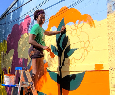 Gloria Jean Martin works on the mural