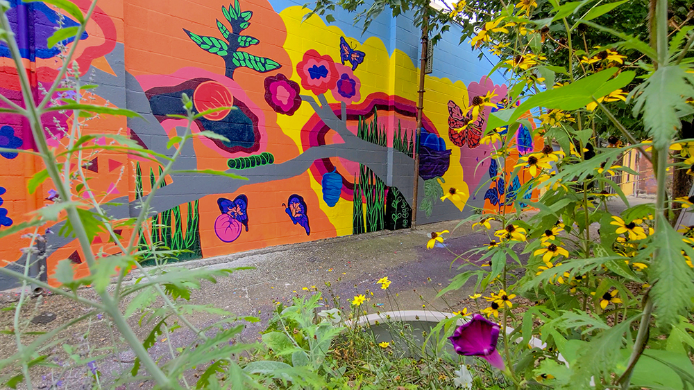 View of the brightly colored mural in the alleyway
