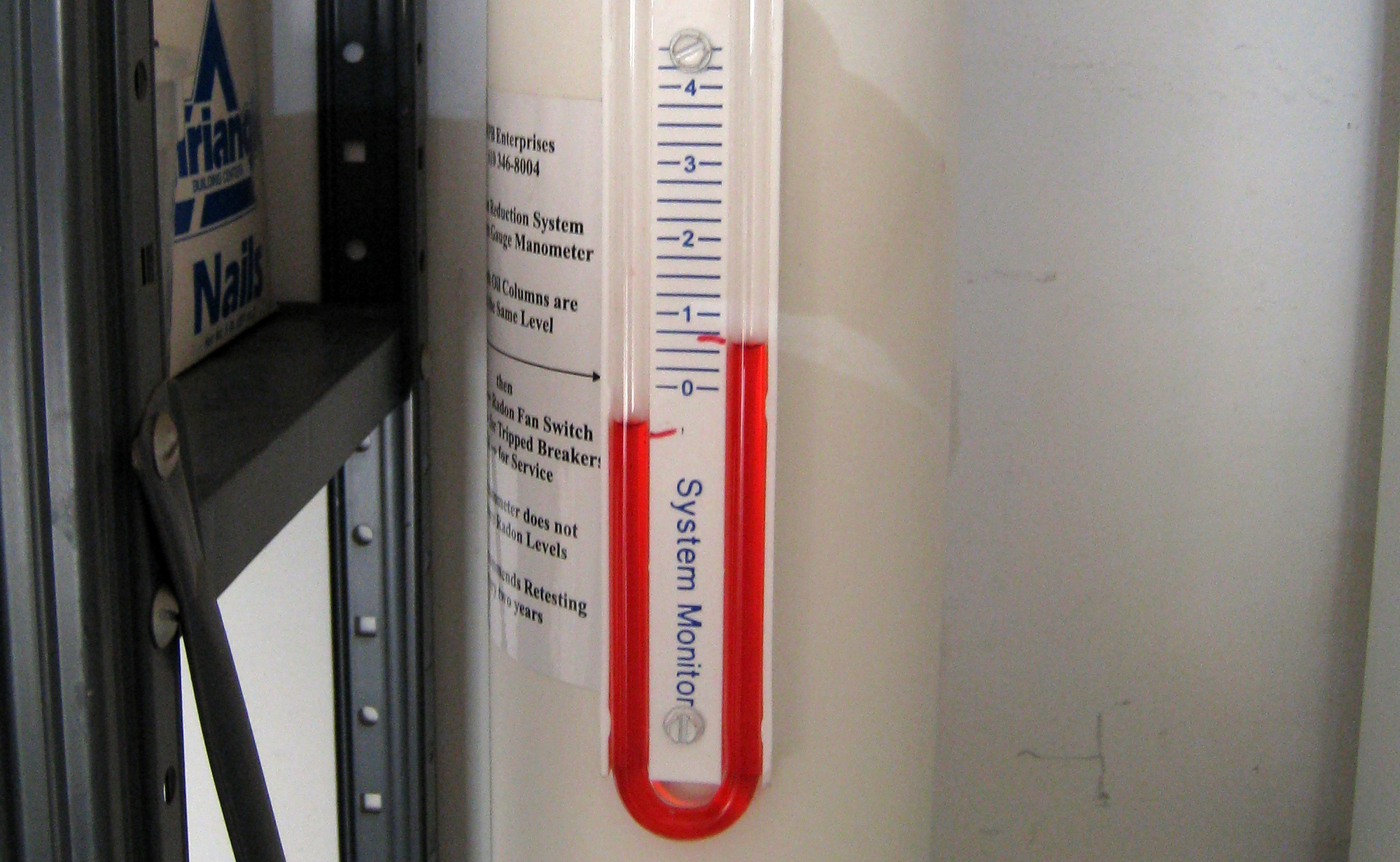 Close-up of a radon mitigation system u-tube